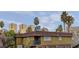 Multi-story building with palm trees under a partly cloudy sky offering an island vibe at 4666 Monterey Cir # 4, Las Vegas, NV 89169