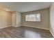 Empty living room with laminate flooring, neutral paint, window and a bright atmosphere at 4666 Monterey Cir # 4, Las Vegas, NV 89169
