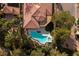 Aerial view of property featuring sparkling pool, lush greenery, and stunning landscaping at 52 Via Paradiso St, Henderson, NV 89011