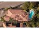 Aerial view showcasing the home's roof, private pool, and surrounding lush greenery at 52 Via Paradiso St, Henderson, NV 89011