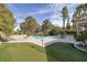 Beautiful backyard area featuring a putting green and sparkling pool at 52 Via Paradiso St, Henderson, NV 89011