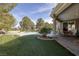 Lush backyard with artificial turf, putting green, and covered patio perfect for outdoor entertaining at 52 Via Paradiso St, Henderson, NV 89011