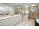 Bright bathroom features a large vanity, soaking tub, and glass shower at 52 Via Paradiso St, Henderson, NV 89011