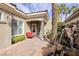Charming front entry with a water feature and seating area on a brick paved walkway at 52 Via Paradiso St, Henderson, NV 89011