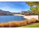 Beautiful golf course and sandy beach with a serene lake and grand clubhouse in the distance at 52 Via Paradiso St, Henderson, NV 89011