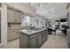 Open concept kitchen featuring granite countertops, stainless appliances, and adjacent living room at 52 Via Paradiso St, Henderson, NV 89011