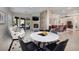 Open concept living room and dining area with large windows, fireplace, and tile floors at 52 Via Paradiso St, Henderson, NV 89011