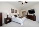 Well-lit main bedroom features a ceiling fan and large TV over a wooden dresser at 52 Via Paradiso St, Henderson, NV 89011