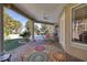Covered patio with brick flooring, ceiling fan, and scenic views of the backyard at 52 Via Paradiso St, Henderson, NV 89011
