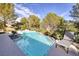 Inviting backyard pool with lush landscaping and a lounge chair to enjoy the outdoors at 52 Via Paradiso St, Henderson, NV 89011
