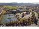 Aerial view of community tennis courts, a pool, and a parking lot near the clubhouse at 52 Via Paradiso St, Henderson, NV 89011