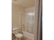 Bathroom with a shower-tub combo, neutral walls and floor, and white fixtures at 5273 Wave Dancer Ln, Las Vegas, NV 89118