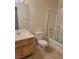 Bathroom with a shower-tub combo, neutral walls and floor, and wood vanity at 5273 Wave Dancer Ln, Las Vegas, NV 89118
