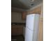 Functional kitchen featuring a white refrigerator and wooden cabinetry at 5273 Wave Dancer Ln, Las Vegas, NV 89118