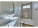 Bathroom featuring light-colored vanity with dual sinks and a tiled shower and tub area at 5573 San Florentine Ave, Las Vegas, NV 89141