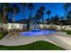 Twilight view of the backyard pool and spa with lounge chairs and lush landscaping under the night sky at 5573 San Florentine Ave, Las Vegas, NV 89141