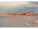 Aerial view of gravel backyard with detached garage and extended covered patio at 620 W Leffner Dr, Pahrump, NV 89060