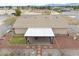 This aerial shows the rear exterior of the home with gravel yard and covered patio at 620 W Leffner Dr, Pahrump, NV 89060