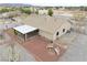 This aerial view shows the rear of the house, patio, and large gravel backyard at 620 W Leffner Dr, Pahrump, NV 89060