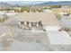 Aerial view showcasing a well-maintained home with a large driveway and mature landscaping at 620 W Leffner Dr, Pahrump, NV 89060