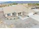 Aerial view of a home with a spacious driveway and tidy landscaping, located near mountain at 620 W Leffner Dr, Pahrump, NV 89060