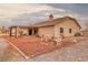 The backyard features a gravel yard, fire pit, covered patio, and neutral-toned exterior at 620 W Leffner Dr, Pahrump, NV 89060
