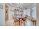 Bright dining room features a decorative chandelier and a classic wood dining set at 620 W Leffner Dr, Pahrump, NV 89060