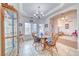 Elegant dining room with a chandelier, wood table, and large windows providing natural light at 620 W Leffner Dr, Pahrump, NV 89060