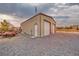 Two-door metal garage exterior, with a gravel driveway, offering a functional space for storage or workshop activities at 620 W Leffner Dr, Pahrump, NV 89060