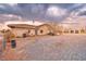 Backyard view of a single-story home with a gravel yard and detached garage, providing ample space at 620 W Leffner Dr, Pahrump, NV 89060