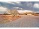 Single-story home with large, graveled front yard offers ample space and serene desert landscaping at 620 W Leffner Dr, Pahrump, NV 89060