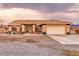 Charming single-story home with desert landscaping, a covered porch, and a two-car garage at 620 W Leffner Dr, Pahrump, NV 89060