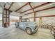 Interior of a garage with a vintage blue truck parked inside, offering both storage and a workspace at 620 W Leffner Dr, Pahrump, NV 89060