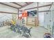 A garage interior features seating, an entertainment setup, and additional workspaces with ample room for hobbies at 620 W Leffner Dr, Pahrump, NV 89060