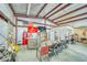 Garage area with seating, workspaces, and a TV, suitable for hobbies, entertainment, or as a flexible workshop space at 620 W Leffner Dr, Pahrump, NV 89060