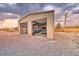 A garage with two vintage vehicles parked inside, including a classic truck and a car, under a cloudy sky at 620 W Leffner Dr, Pahrump, NV 89060