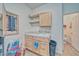 Functional laundry room with storage shelves and direct access to the adjacent half bathroom at 620 W Leffner Dr, Pahrump, NV 89060