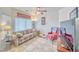 Living room with large picture window and comfortable seating arrangement including sofa and chair at 620 W Leffner Dr, Pahrump, NV 89060