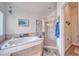Main bathroom featuring a soaking tub, glass-enclosed shower, and tile flooring at 620 W Leffner Dr, Pahrump, NV 89060