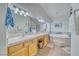 Bright bathroom with double sinks, a soaking tub, and a separate shower area at 620 W Leffner Dr, Pahrump, NV 89060
