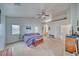 Bright main bedroom with carpet, vaulted ceiling, and a ceiling fan at 620 W Leffner Dr, Pahrump, NV 89060