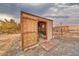 Angle view of shed with doors open and tiled entrance with storage inside at 620 W Leffner Dr, Pahrump, NV 89060