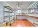 A well-organized storage room with shelving, a workbench area, and a window, ideal for hobbyists or those needing storage at 620 W Leffner Dr, Pahrump, NV 89060