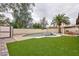 A beautiful backyard features a private pool, lush artificial grass, and a storage shed at 6309 Fairbanks Rd, Las Vegas, NV 89103