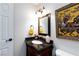 Bathroom featuring a dark vanity, gold fixtures, and an ornate painting at 6309 Fairbanks Rd, Las Vegas, NV 89103