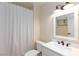 Bathroom with white shower curtain, vanity, and a window at 6309 Fairbanks Rd, Las Vegas, NV 89103