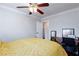 This bedroom features a ceiling fan, desk area, and a comfortable bed at 6309 Fairbanks Rd, Las Vegas, NV 89103