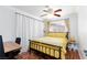 Bright bedroom with a yellow patterned bed, decorative lighting, desk, and lots of natural light at 6309 Fairbanks Rd, Las Vegas, NV 89103