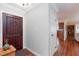 Entryway with a dark wood door, adjacent white doors, hardwood floors, and a view into the living area at 6309 Fairbanks Rd, Las Vegas, NV 89103