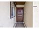 Close-up of the solid wood front door with decorative details and a side window at 6309 Fairbanks Rd, Las Vegas, NV 89103
